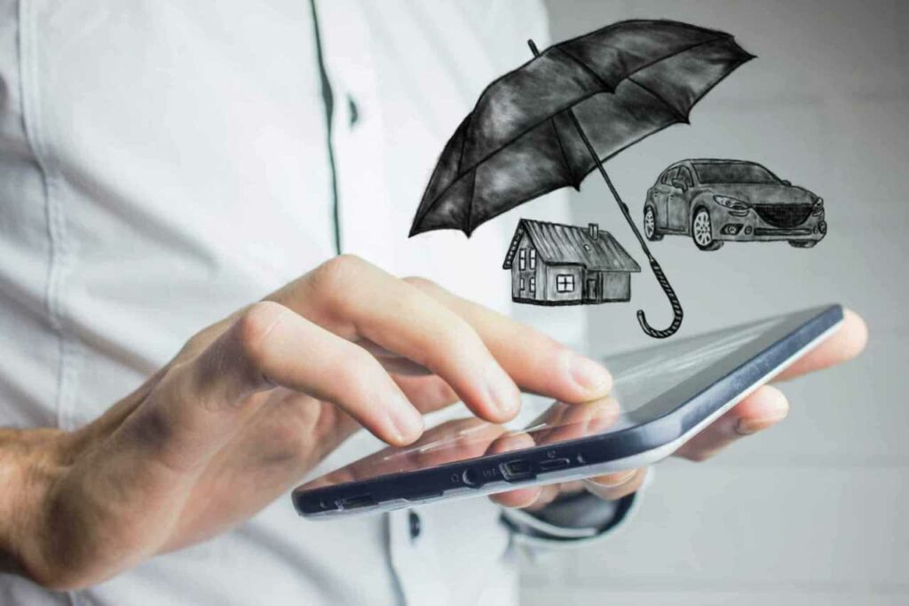 man using tablet to look for business insurance terms umbrella policy Harvey Insurance