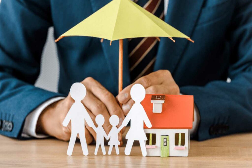 an image of a house and family with an umbrella Harvey Insurance