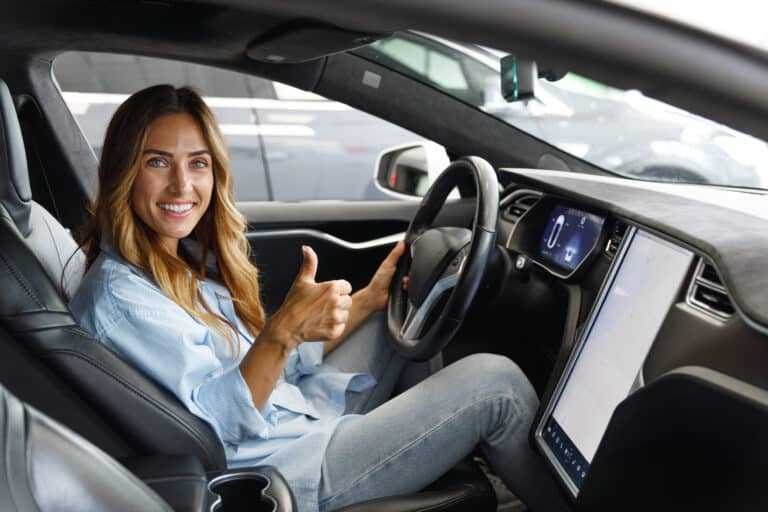 female driver raising a thumbs up car insurance rates Harvey Insurance